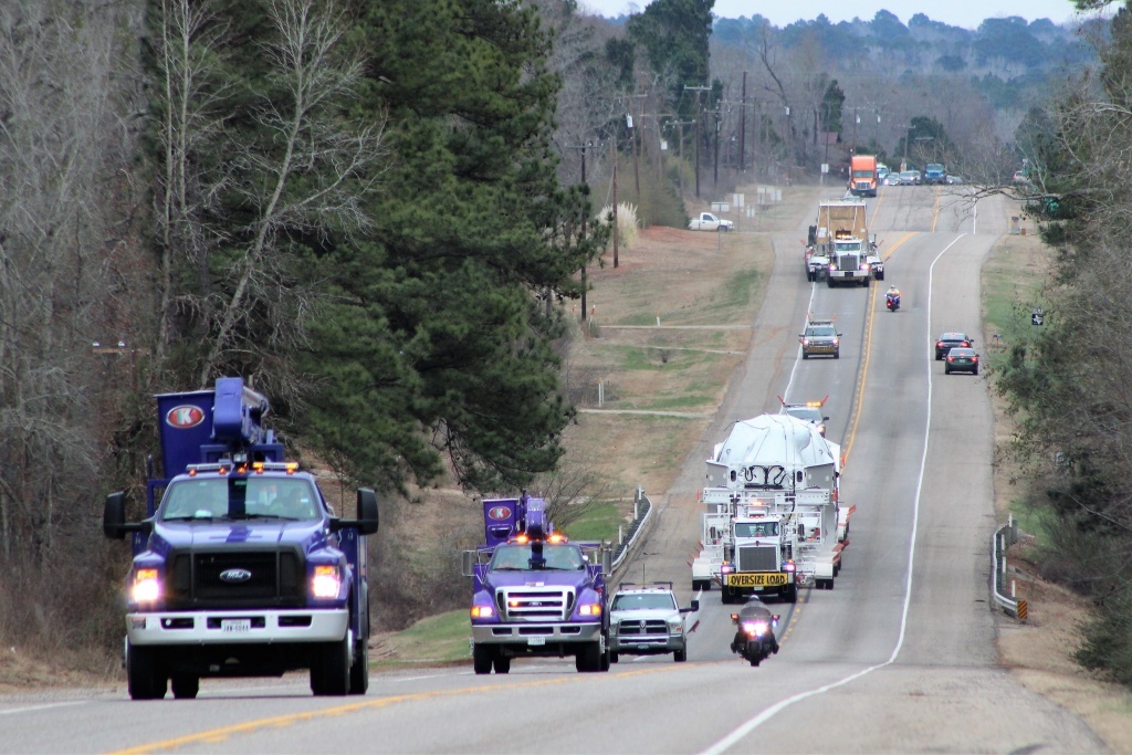 Kenco's purple bucket trucks escorted a steam turbine and generator to Canadian border.
